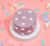 Mini Filled Sponge Cake With Daisies In Purple On A Pink Background